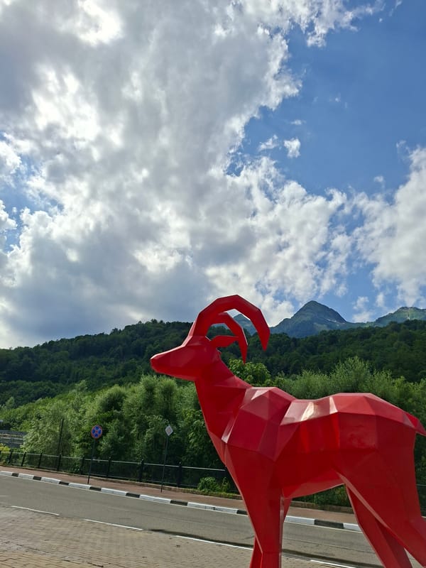 Red geometric goat sculpture near cable car station, Estosadok