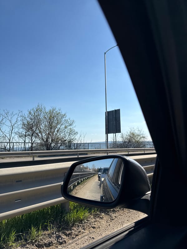 Highway traffic observed via side mirror near Varna