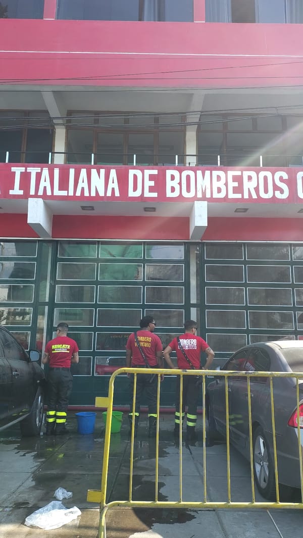 Firefighters outside Italian fire company station in Chorrillos, Peru