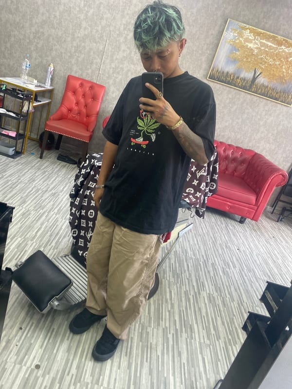 Person takes selfie in art-decorated indoor space, Kuta