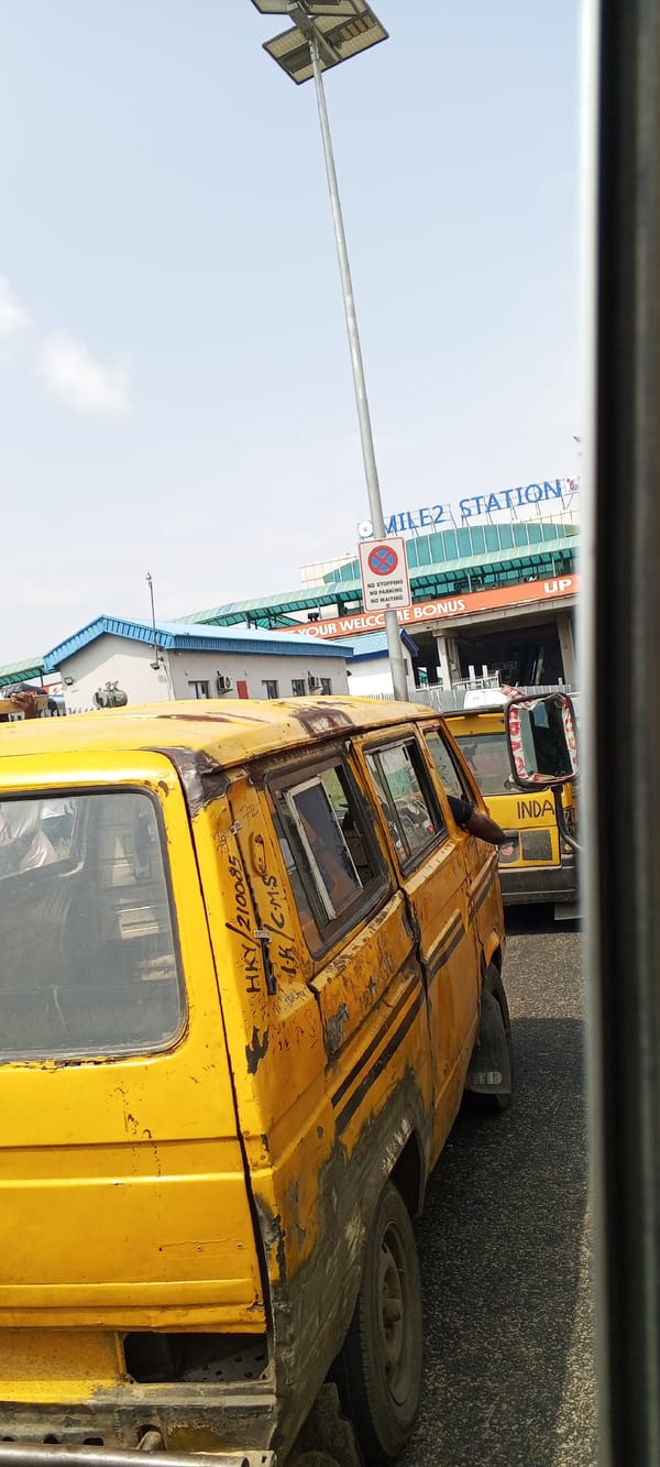 Street vendors and traffic along a busy Lagos roadside