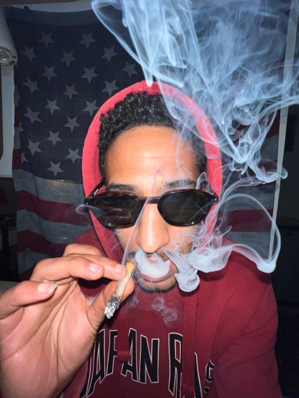 Man smoking, writing on fogged window in Tangier residence