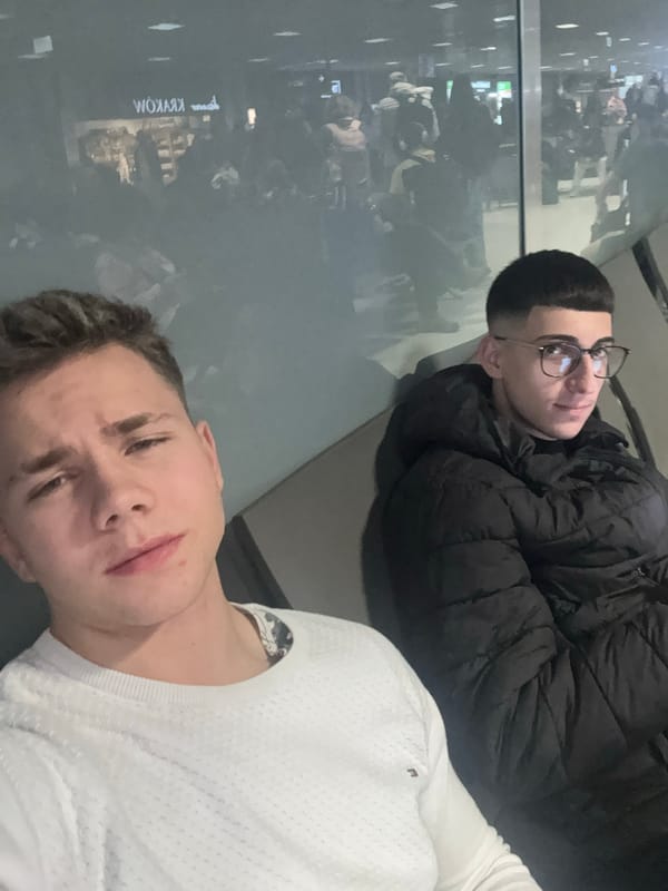 Passengers wait and pose for photos at Kraków Airport