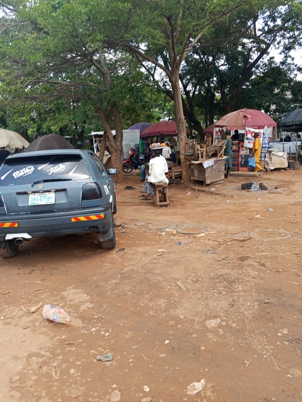 Daily street life documented in unpaved Abuja neighborhood