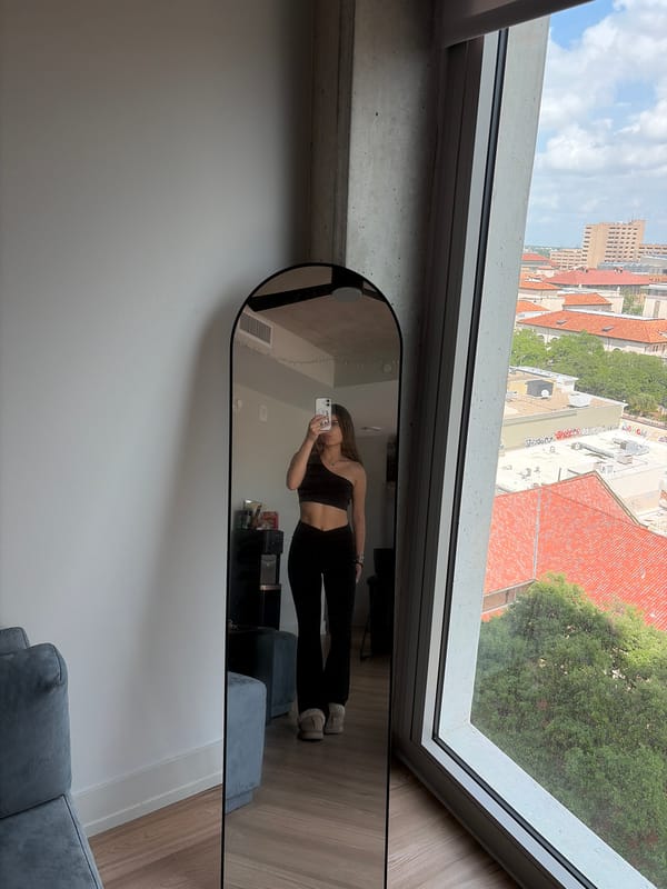 Woman takes mirror selfie in Austin apartment