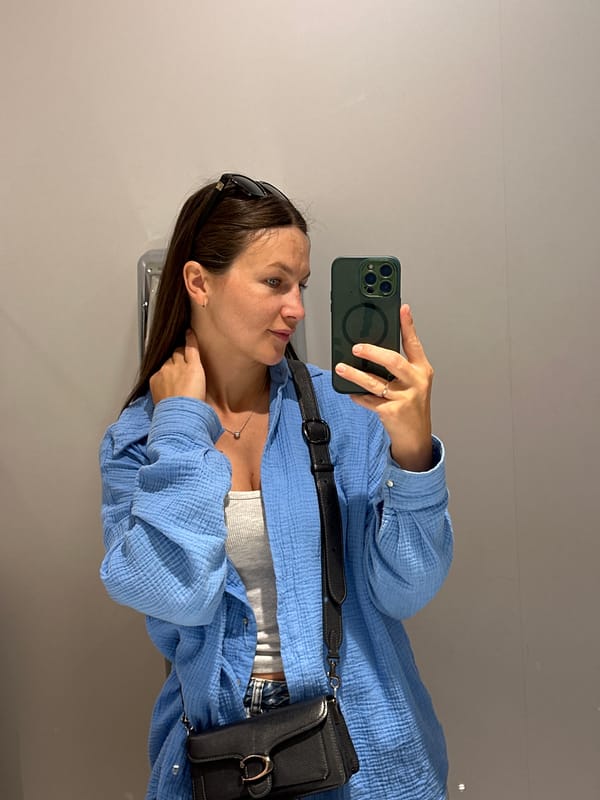 Woman takes selfie near waterway building