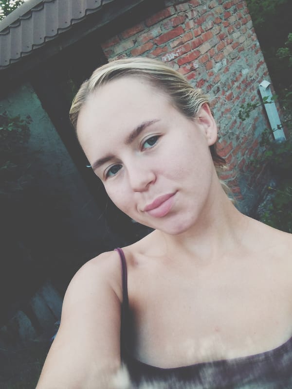 Outdoor selfie against brick wall in Radisne, Ukraine