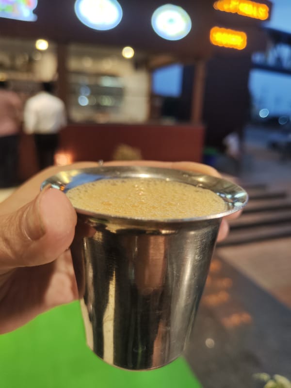 Beverage service documented at Mudugurki establishment with decorative lighting