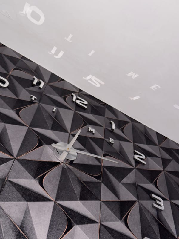 Decorative letter-numeral clock observed on patterned wall in Russia