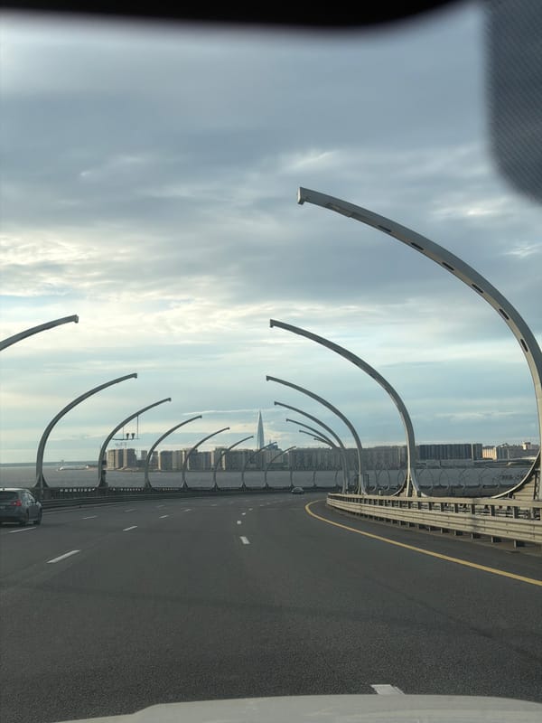 Highway drive past bridges, skyline, and city streets