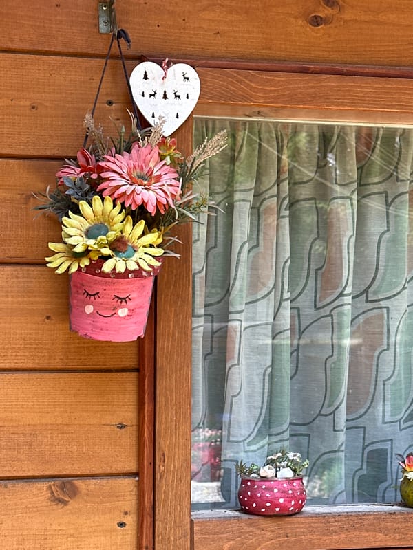 Rustic cabin details and garden decor in Borno, Italy