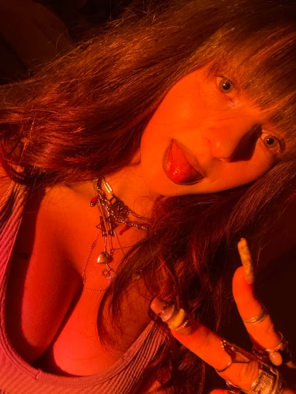 Woman conducts late-night photo session in dramatic lighting, Raanana