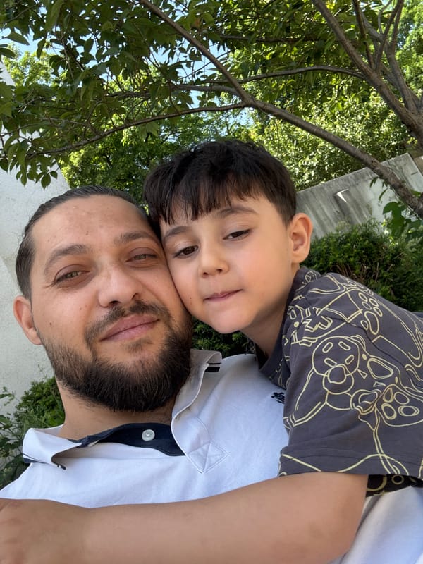 Father and child share quiet moment at gas station