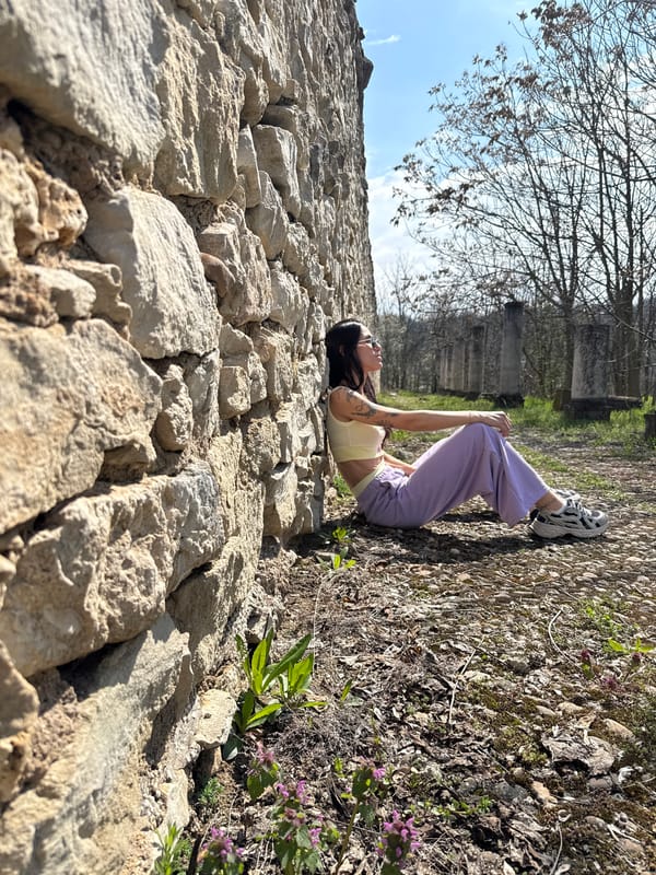 Woman rests on stone wall in Pleven