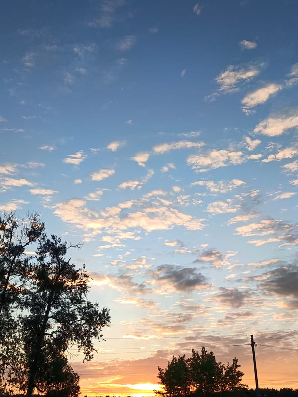 Sunset over rural Belarus, open skies and a railway crossing
