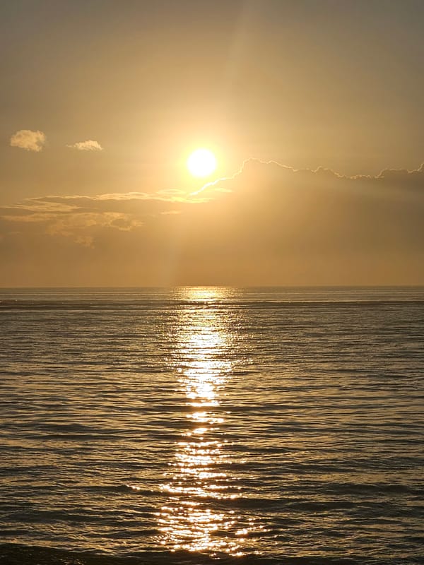 Sunset at Sanur Beach, Bali's coastline at golden hour