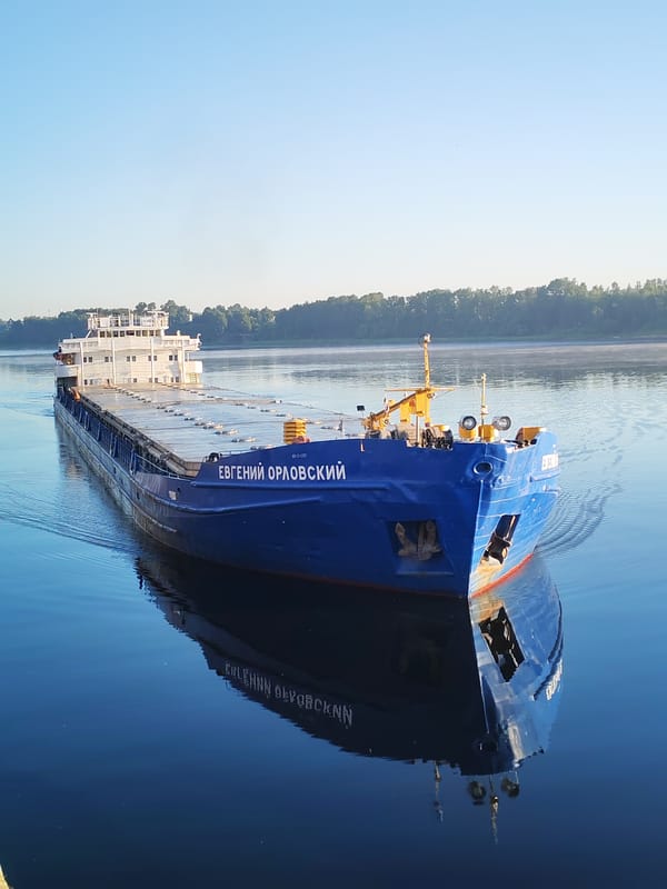 Russian cargo barge spotted from the riverbank at dawn