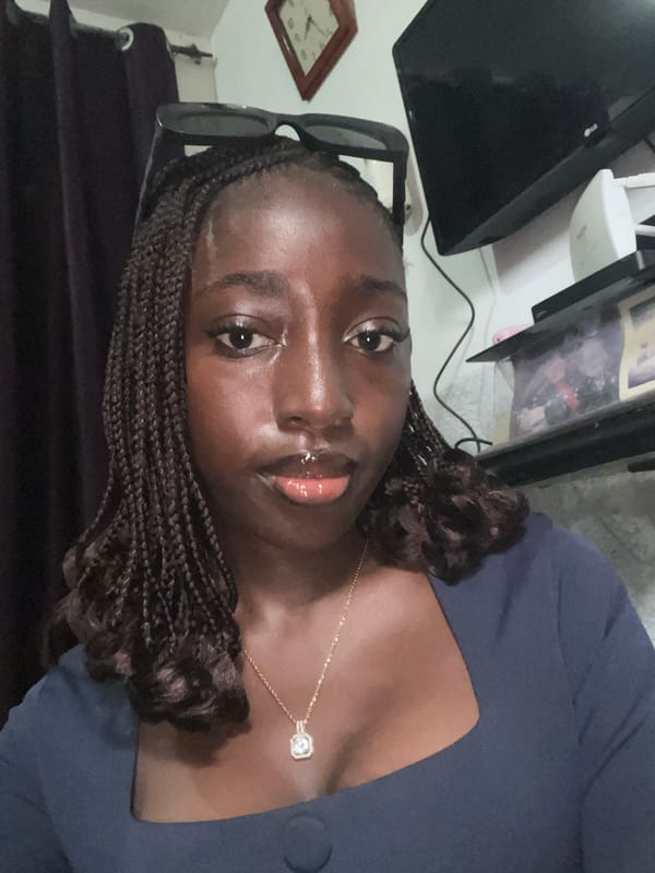 Woman photographed multiple times in navy dress, Abuja Nigeria