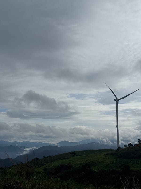 Wind turbines documented across mountainous Vietnam region during cloudy morning