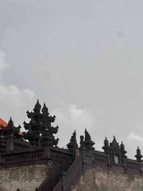 Traditional Balinese temple gate observed under grey skies