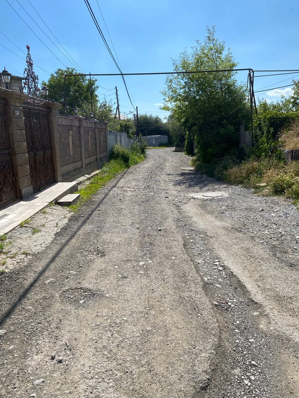 Quiet streets and stone buildings in Gyumri on a sunny afternoon.