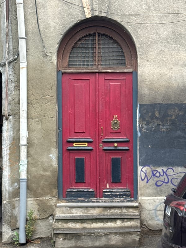 Red arched doorway photographed in Tbilisi, Georgia
