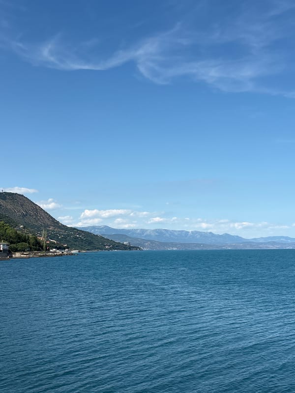 Calm coastline and hillside buildings along the Crimean shore