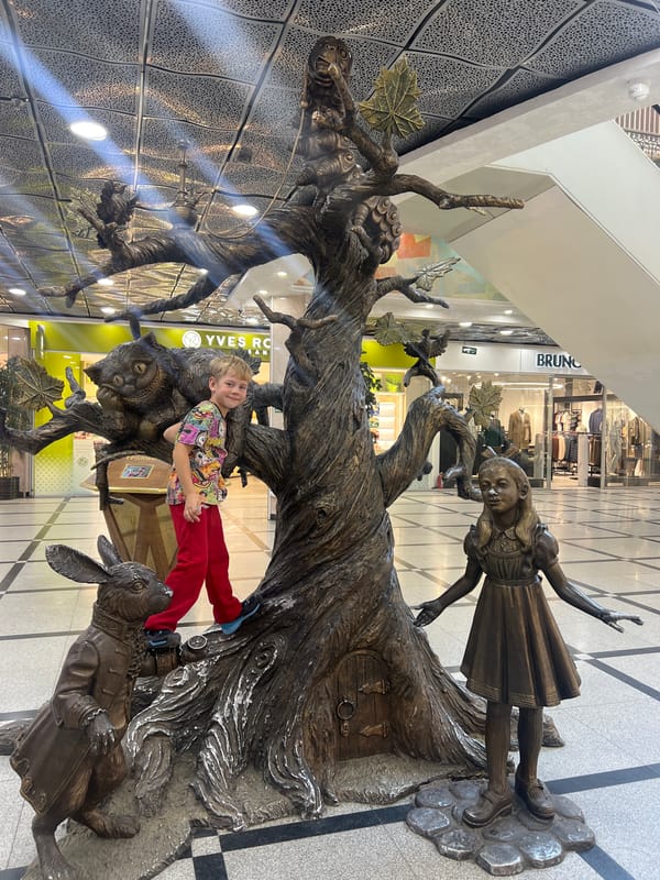 Boy climbs Alice in Wonderland sculpture in Yekaterinburg
