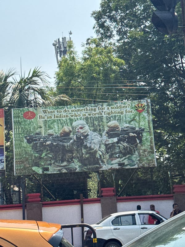Early morning street scene near army recruitment billboard in Kolkata