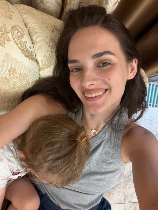 Relaxed couch selfie in Ufa, gold crescent necklace detail