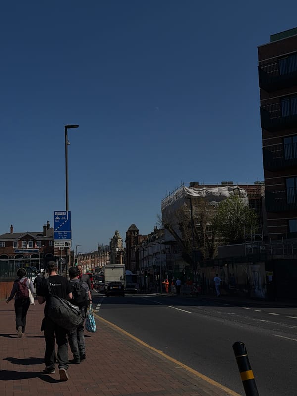 London street scene photographed sideways under clear blue sky