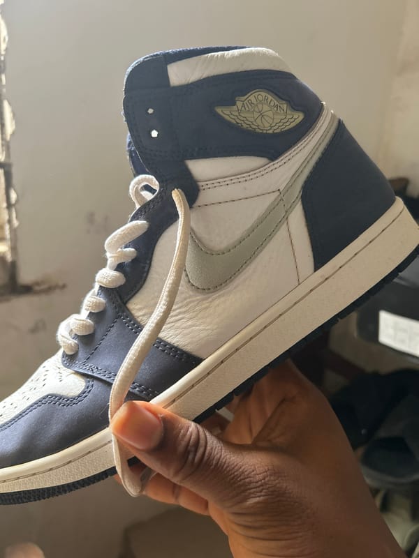 Person examines Nike Air Jordan sneakers in Ashipa, Nigeria