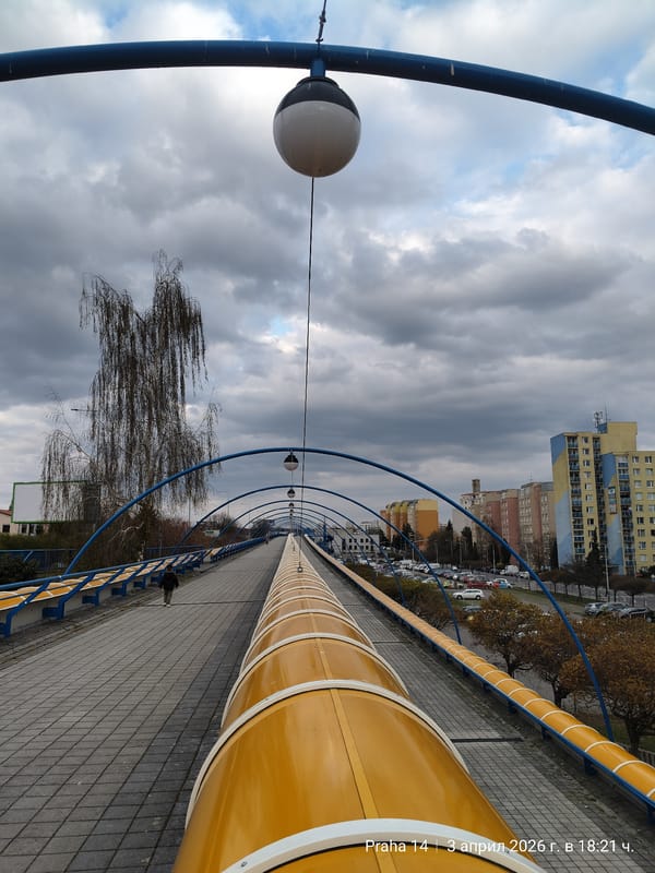 Child spotted on Prague pedestrian bridge during overcast afternoon