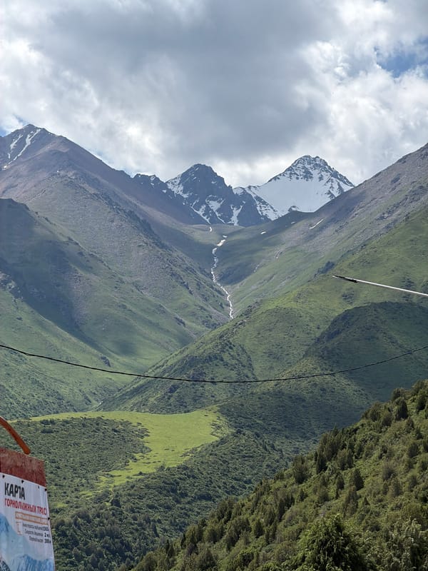 Kashka Suu ski resort in summer, lifts quiet and hills green