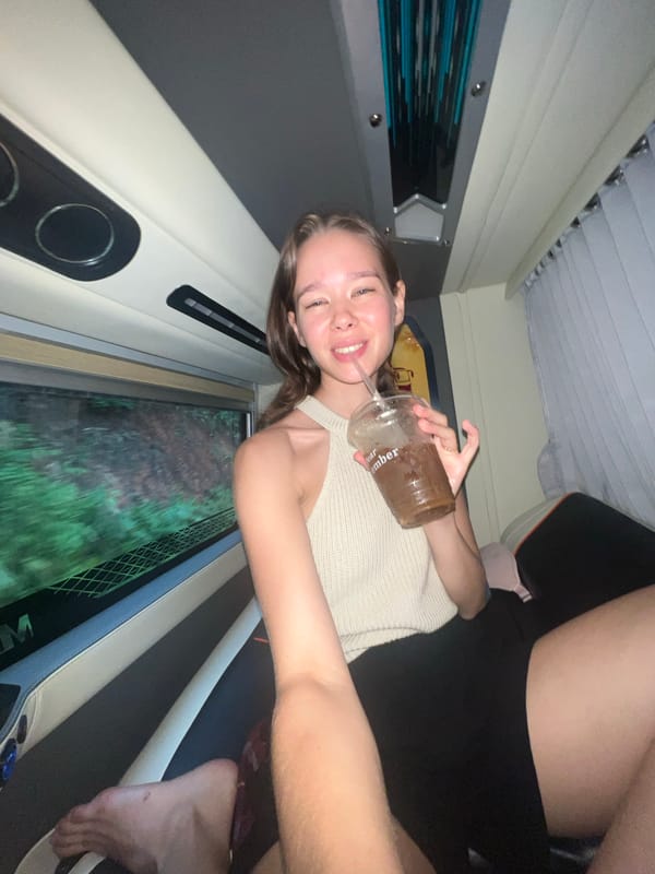 Woman smiles during overnight bus journey in Bo Y, Vietnam