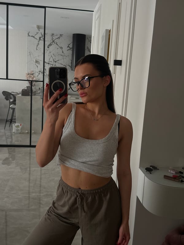 Mirror selfie in a modern Kyiv apartment, casual morning.