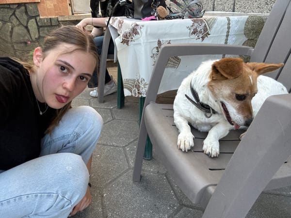 Woman photographs herself with dog on Bulgarian patio