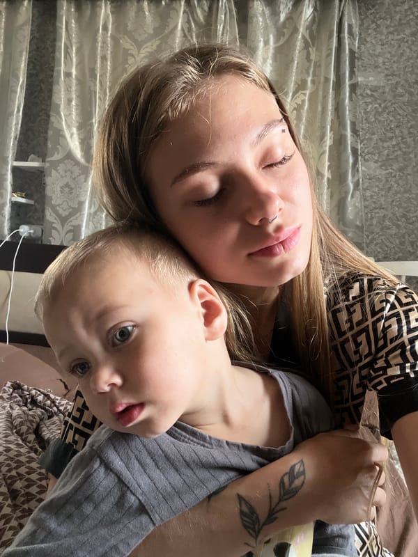 Mother and child rest together in early morning domestic moment