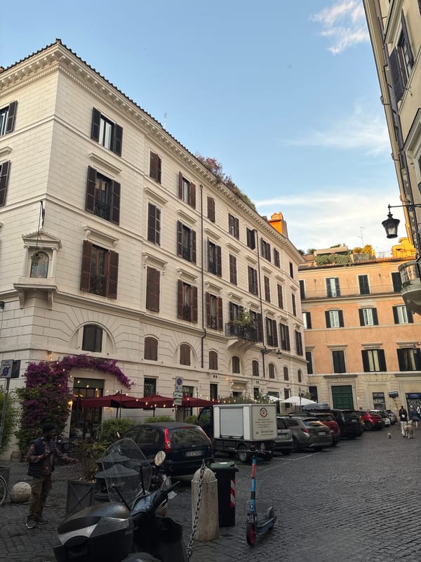 Rome street scene shows historic buildings including religious structure