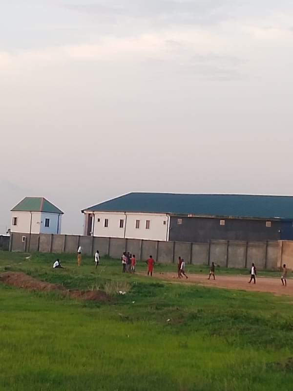 Rural Nigeria communities captured in evening field gatherings