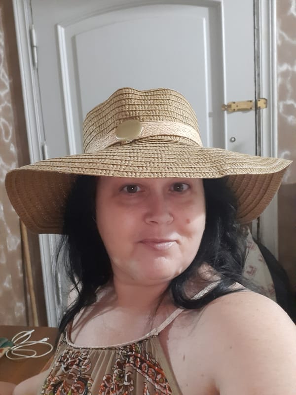 Woman photographed alongside religious artwork in Al Hadaba, Egypt