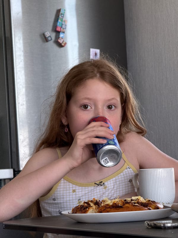 Girl drinks from colorful can in Rostov-on-Don