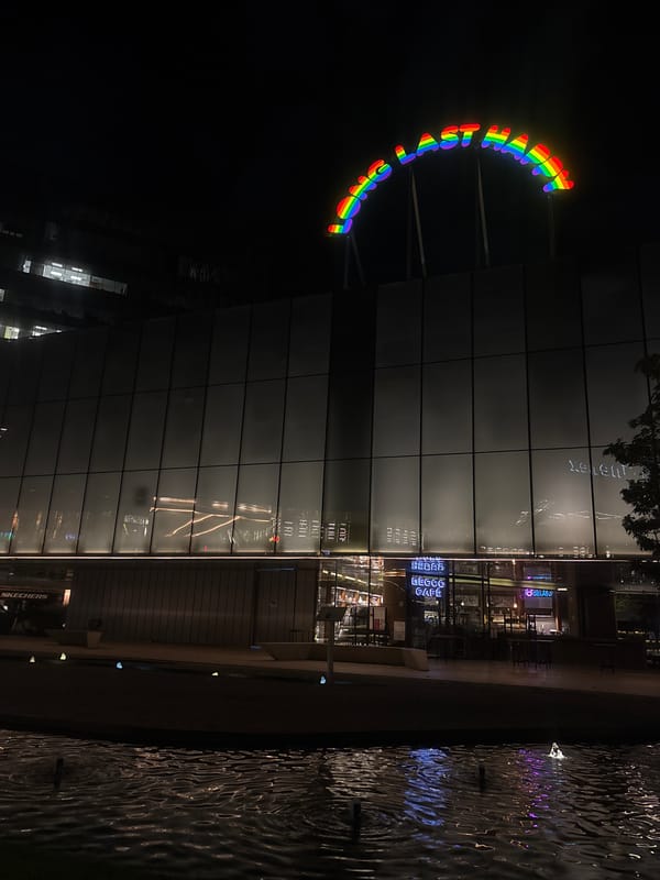 Rainbow 'LOVE WINS' sign illuminated at urban building