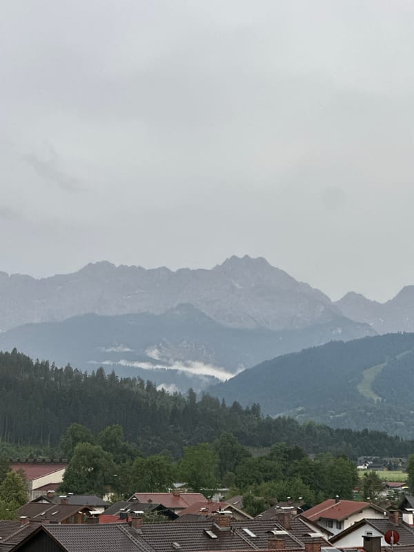 Overcast evening over Garmisch-Partenkirchen's rooftops and misty Alps