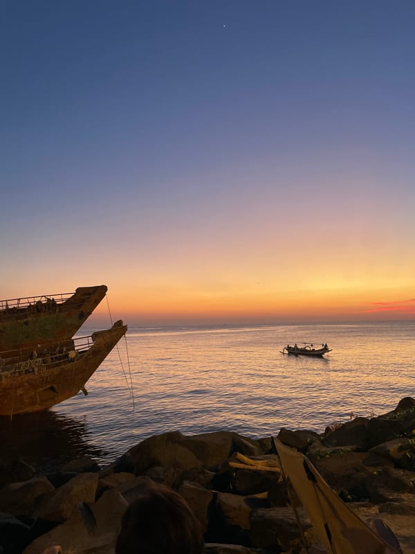 Sunset drinks at a Manado beach bar with a shipwreck view