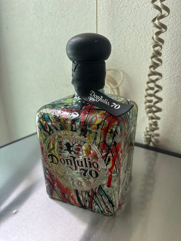 Paint-splattered tequila bottle documented in Mexico City suburb