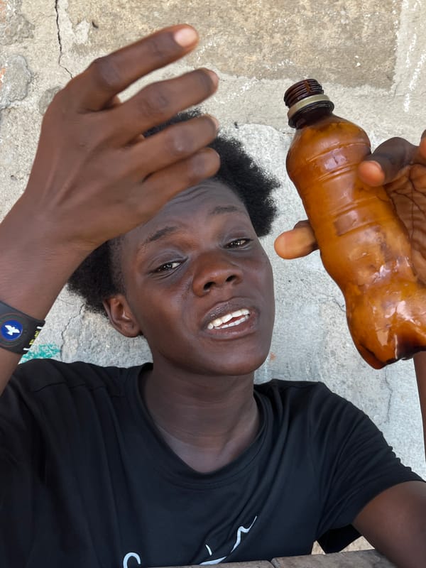 Person with bottle rests on concrete in Badagry