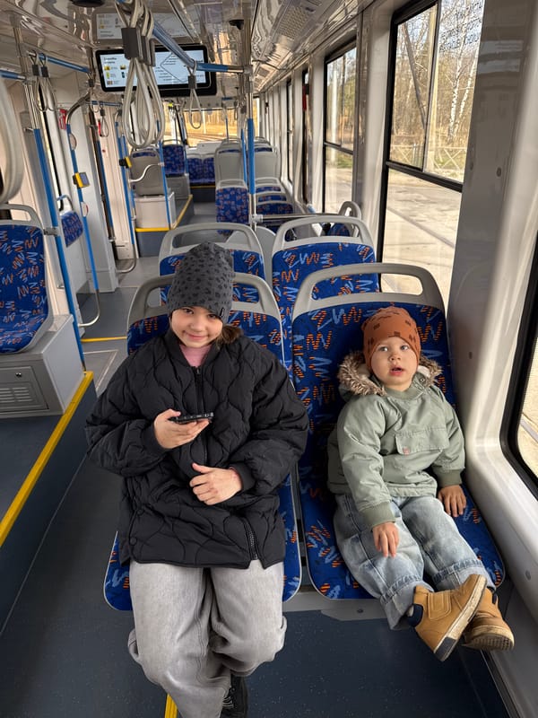 Morning commuters and children ride public transport in Rusanovo
