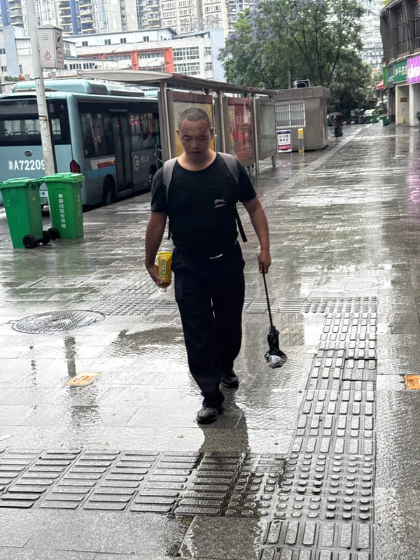 Rainy evening brings umbrellas and wet streets to Longta