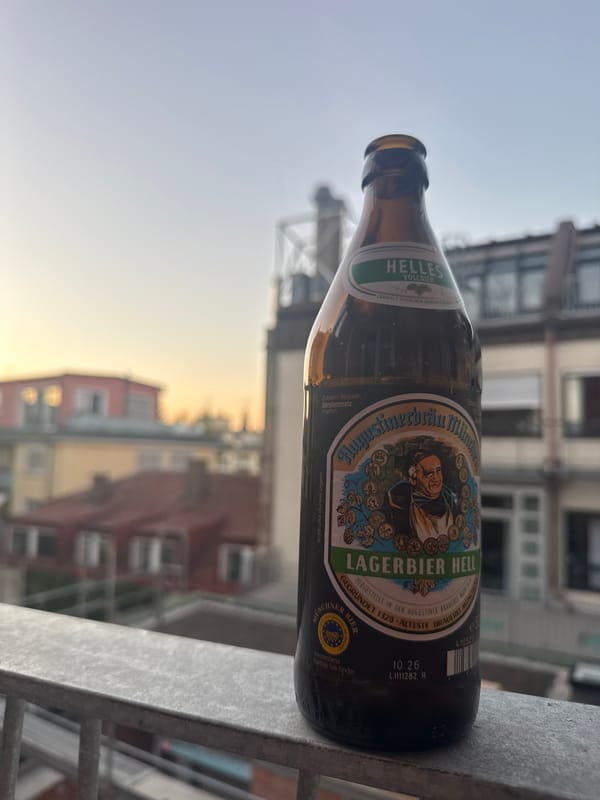 Person enjoys beer and relaxation on Munich balcony